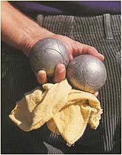 Player holding petanque balls